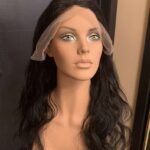 Human hair wig natural very dark brown wavy hair, facing right.