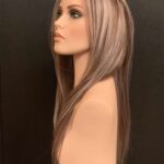 Human hair wig ash blond highlights light brown base, 23” long 200% density, left side view.