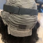 Human hair wig natural very dark brown wavy hair, showing adjustable strap and comb.