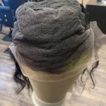 Human hair wig natural very dark brown wavy hair, showing adjustable strap, underside view.